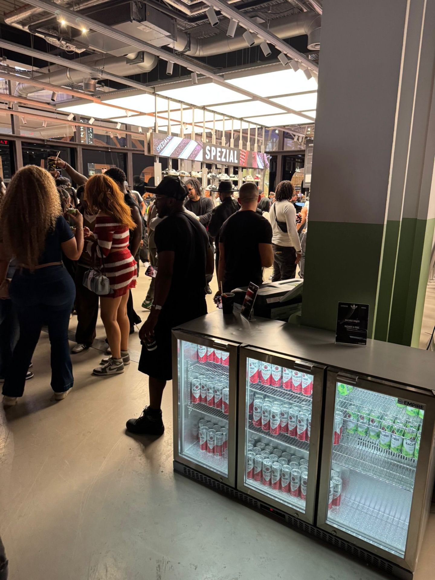 Triple glass door drinks fridges serving guests at a busy activation