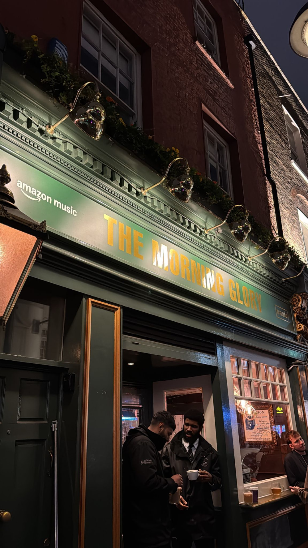 Branded pub exterior takeover with signage and lighting for a music launch