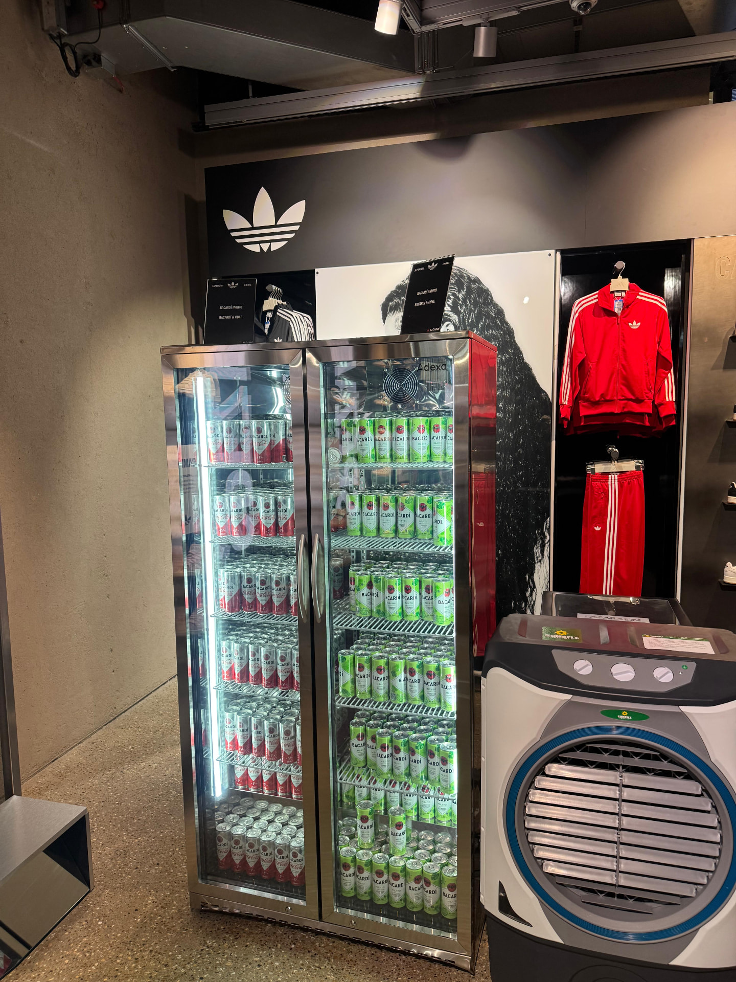 Stocked bottle coolers and branded bar setup at an event