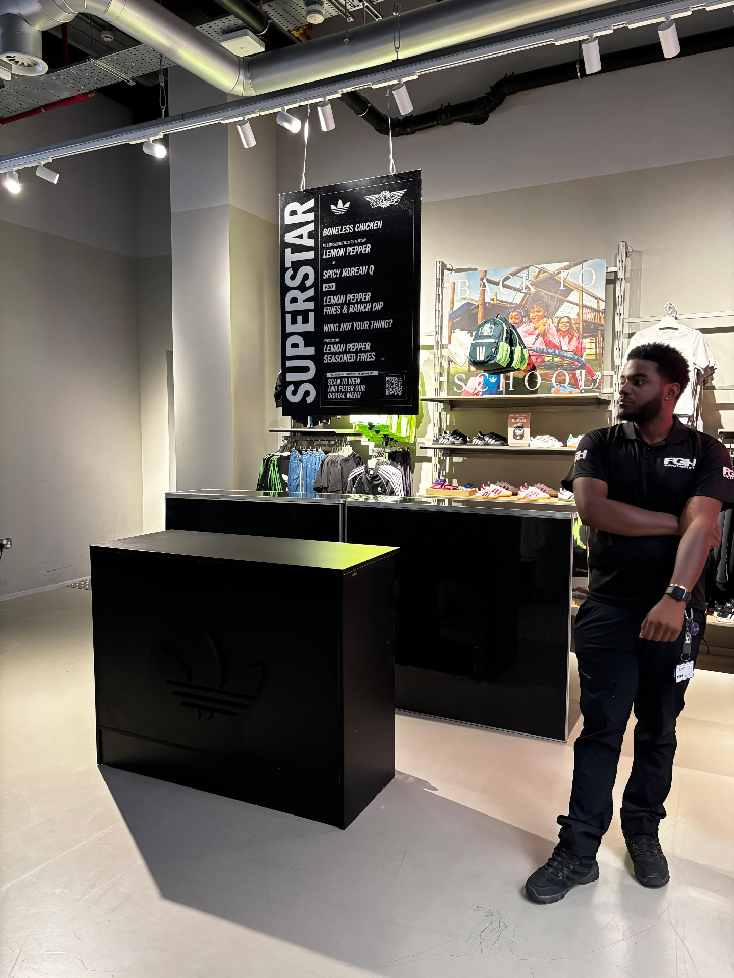 Black bar counter units and event signage in a retail space